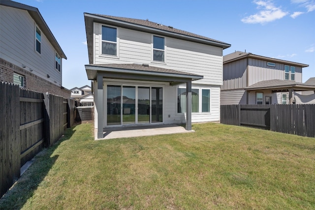 rear view of property with a lawn and a patio