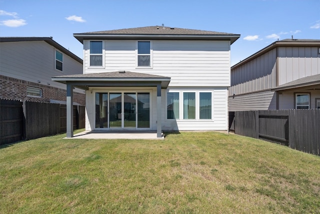 back of property with a yard and a patio area