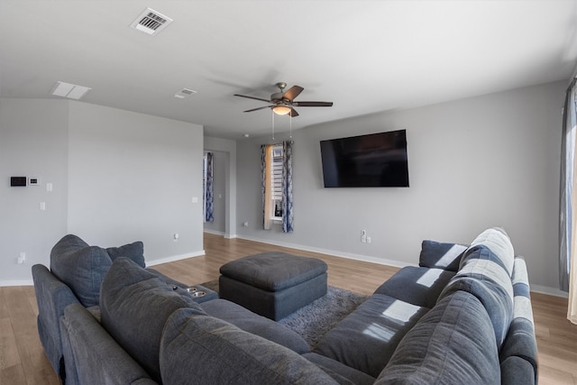 living room featuring light wood-type flooring and ceiling fan