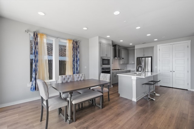 dining room with dark hardwood / wood-style flooring and sink