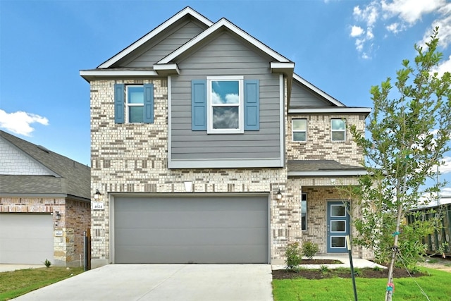 view of front of property with a front yard and a garage