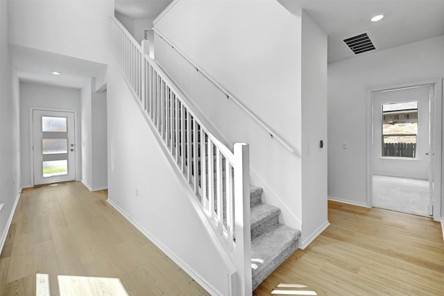 staircase with wood-type flooring