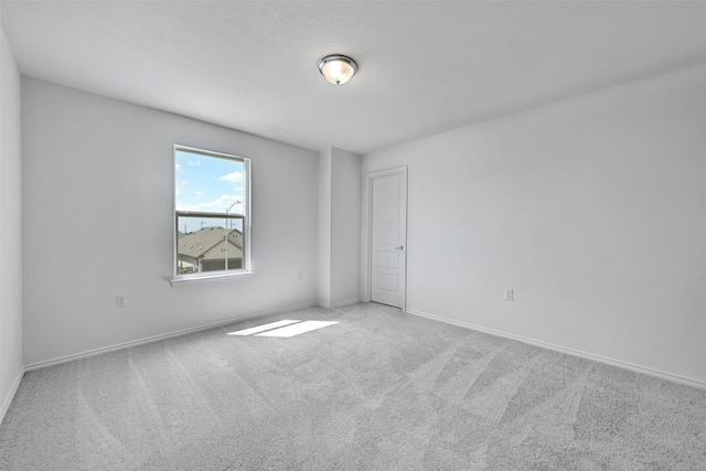 empty room featuring light colored carpet