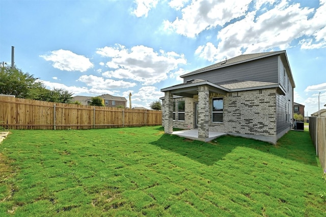 back of property with a patio, cooling unit, and a yard