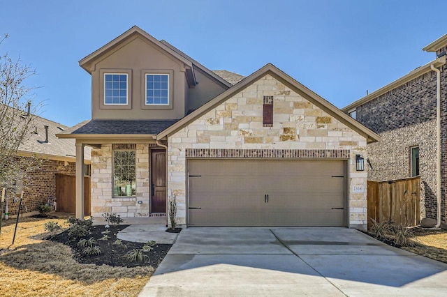 view of front of home featuring driveway, stone siding, an attached garage, and roof with shingles