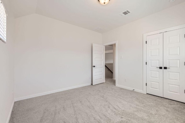 unfurnished bedroom with visible vents, baseboards, carpet, and a closet