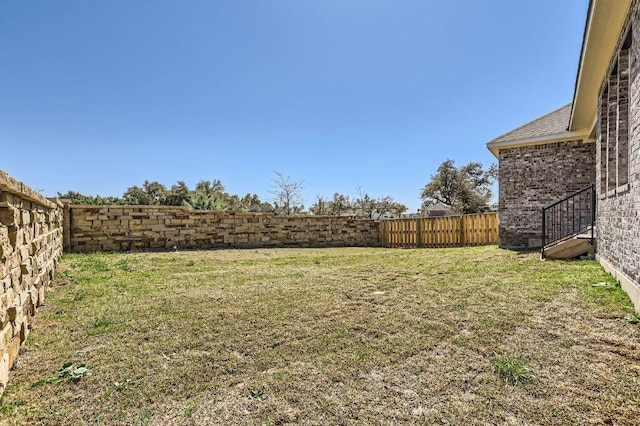 view of yard with a fenced backyard