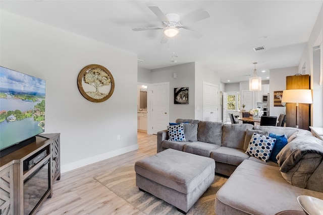 living room with ceiling fan and light hardwood / wood-style floors