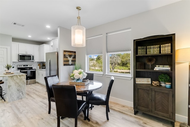 dining area with light wood-type flooring