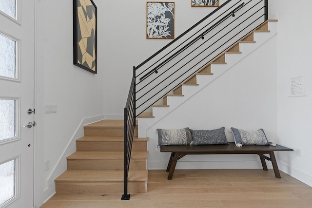 stairs featuring hardwood / wood-style floors