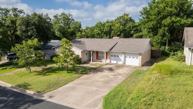 ranch-style house featuring a garage and a front yard