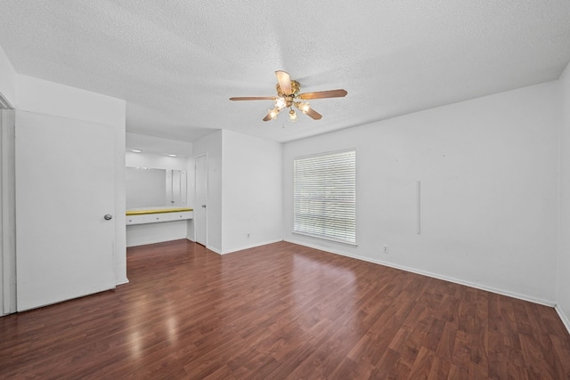 unfurnished living room featuring ceiling fan, dark hardwood / wood-style flooring, and a textured ceiling