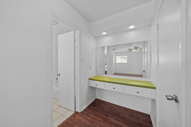 bathroom with vanity, a textured ceiling, wood-type flooring, and ceiling fan