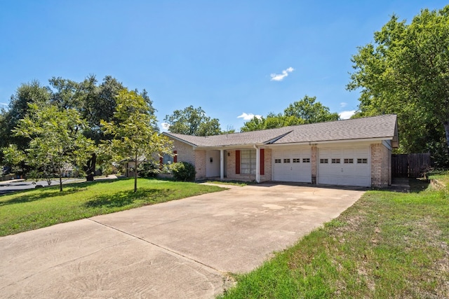 ranch-style house with a garage and a front lawn