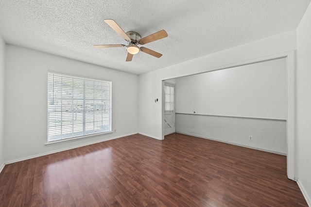 spare room featuring ceiling fan, dark hardwood / wood-style flooring, and a textured ceiling