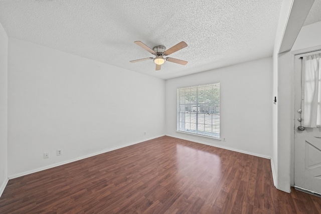 unfurnished room featuring dark wood-type flooring, ceiling fan, and a textured ceiling