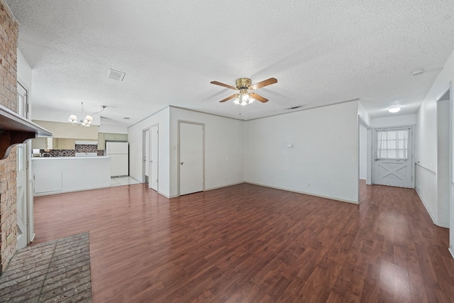 unfurnished living room featuring a textured ceiling, ceiling fan with notable chandelier, hardwood / wood-style flooring, and a fireplace