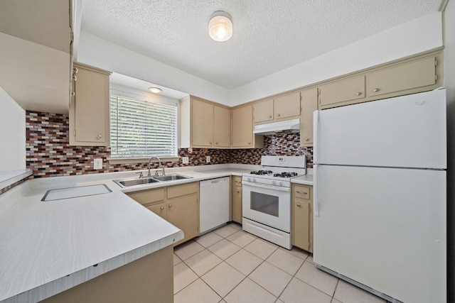 kitchen featuring a textured ceiling, white appliances, sink, decorative backsplash, and light tile patterned flooring