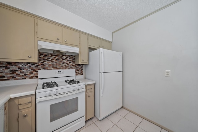 kitchen with a textured ceiling, light tile patterned floors, white appliances, and tasteful backsplash