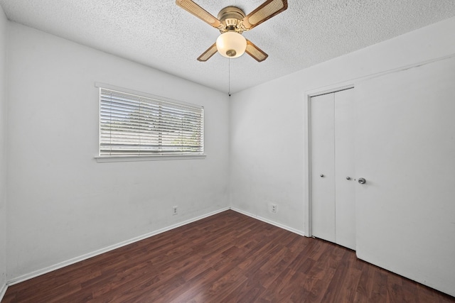 unfurnished bedroom with a closet, a textured ceiling, ceiling fan, and dark hardwood / wood-style floors