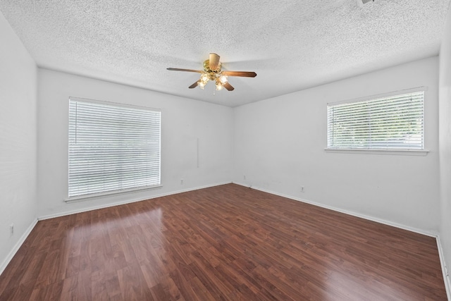 spare room with ceiling fan, dark hardwood / wood-style flooring, and a textured ceiling