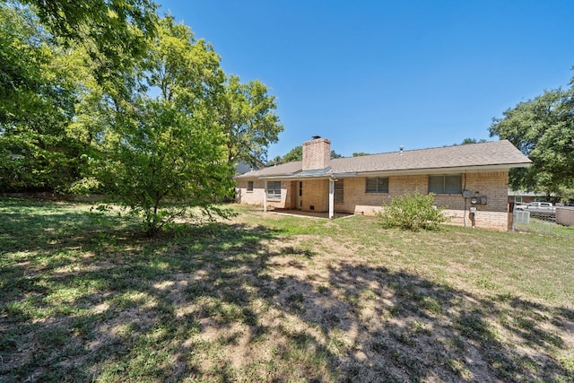 back of house featuring a yard and a patio