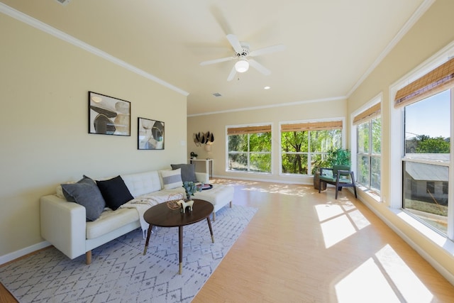 living room featuring crown molding, a healthy amount of sunlight, and ceiling fan