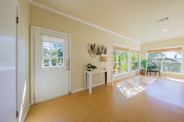 doorway to outside with light wood-type flooring and ornamental molding