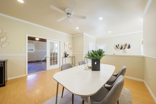 dining area with ceiling fan, ornamental molding, and light hardwood / wood-style flooring