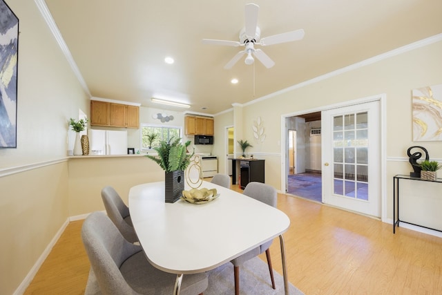 dining room with crown molding, french doors, light hardwood / wood-style flooring, and ceiling fan