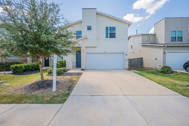 view of front of home with a garage and a front lawn