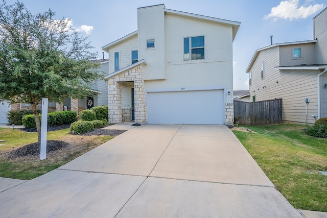 view of front of property with a garage and a front lawn