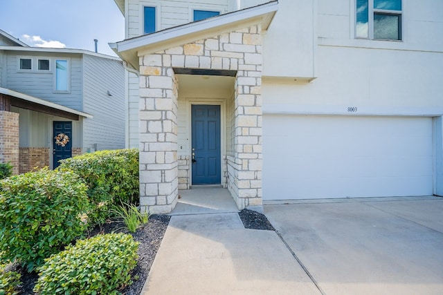 view of exterior entry with a garage