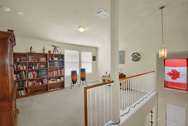 hallway with carpet and a textured ceiling