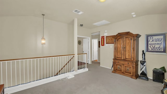 corridor featuring lofted ceiling and light colored carpet