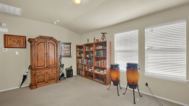 miscellaneous room with light colored carpet and lofted ceiling