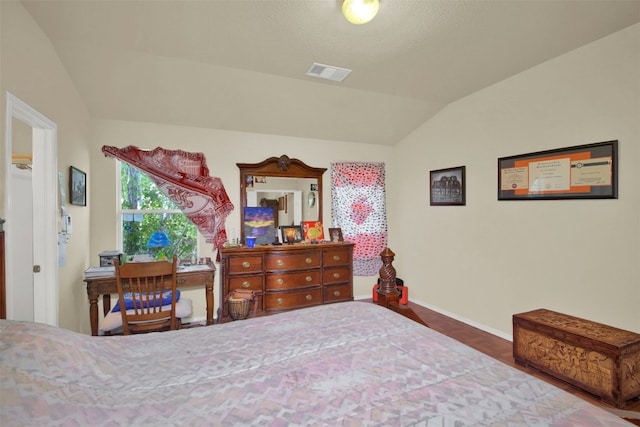 bedroom featuring vaulted ceiling and hardwood / wood-style flooring