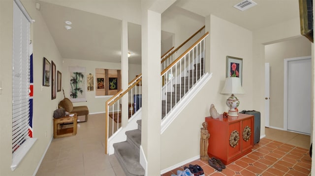 stairway with tile patterned floors