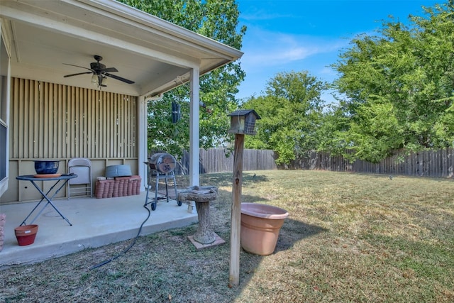 view of yard with a patio and ceiling fan