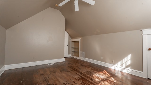 bonus room featuring vaulted ceiling, built in features, and dark hardwood / wood-style flooring