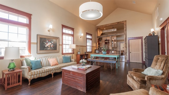 living room featuring a wealth of natural light, high vaulted ceiling, and dark hardwood / wood-style flooring