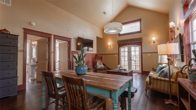 dining space featuring french doors, high vaulted ceiling, and dark hardwood / wood-style flooring