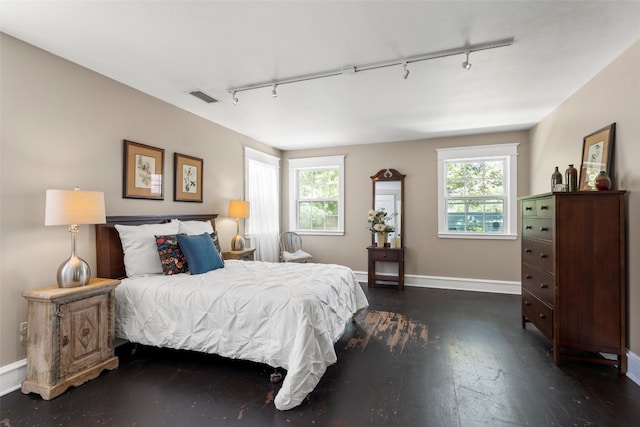 bedroom with dark wood-type flooring and rail lighting