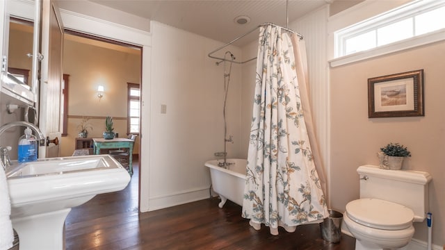 bathroom featuring toilet, shower / tub combo, and hardwood / wood-style floors