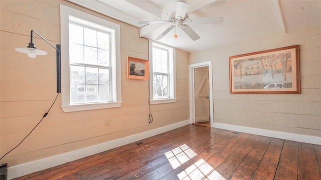 unfurnished room with ceiling fan and dark hardwood / wood-style flooring