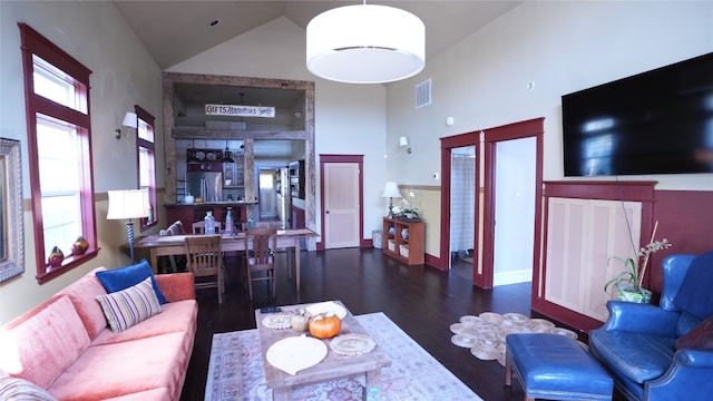 living room featuring dark hardwood / wood-style floors and high vaulted ceiling