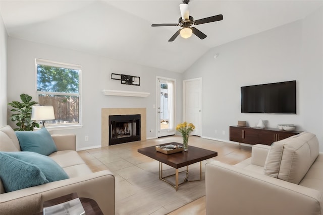 tiled living room featuring lofted ceiling and ceiling fan