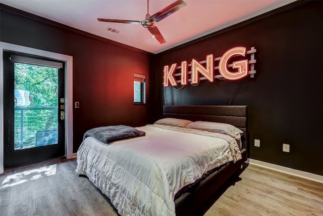 bedroom featuring ceiling fan, wood-type flooring, access to outside, and ornamental molding