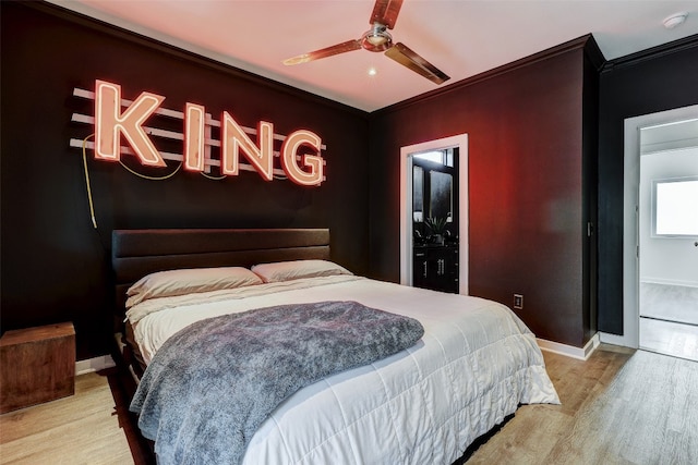 bedroom featuring light wood-type flooring, ceiling fan, and ornamental molding