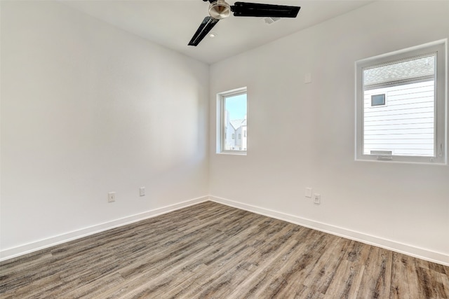 unfurnished room with hardwood / wood-style flooring and ceiling fan